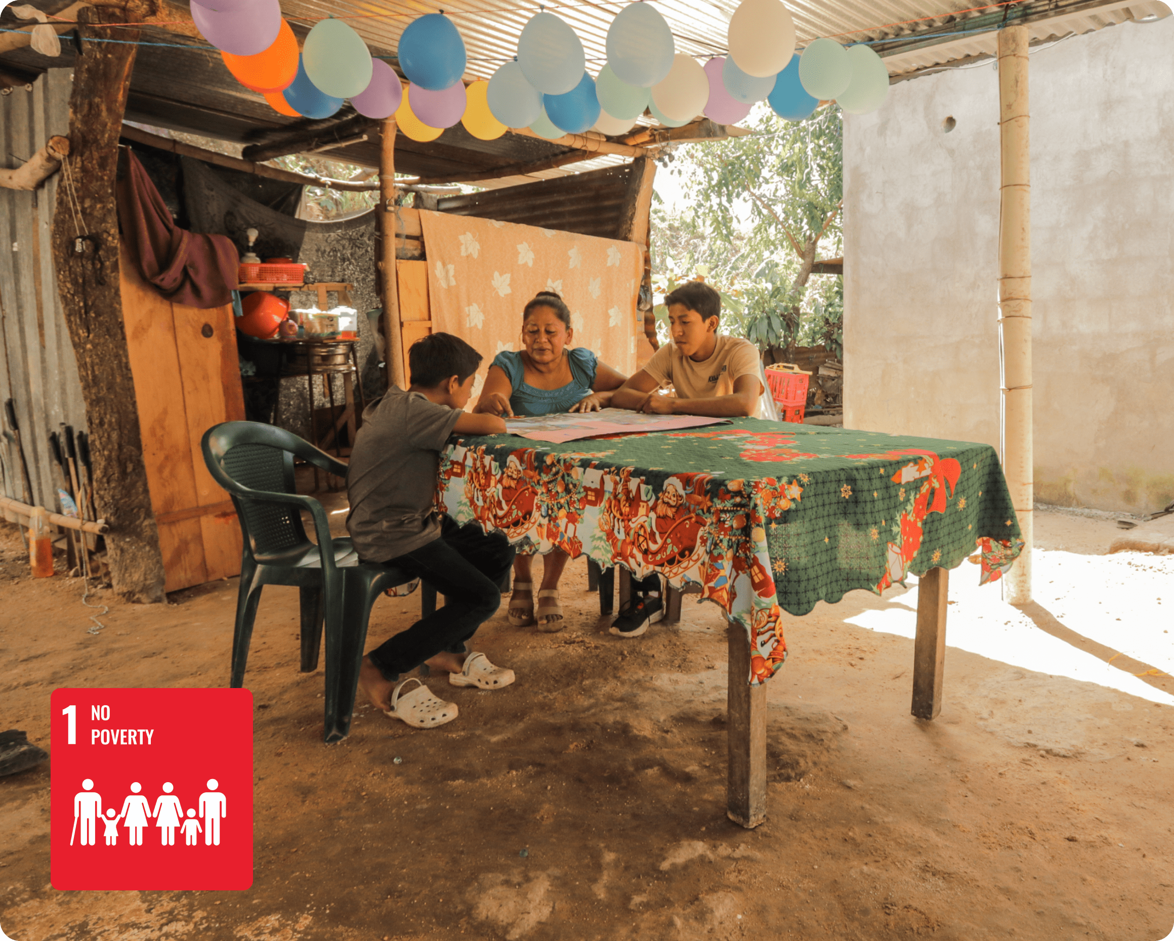 Santos, the mother of a sponsored child in Guatemala, stands beneath the new roof at her home